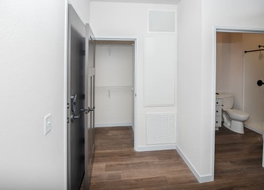 an open door leading into a bathroom with a shower and toilet at The Crossings  at Windsong, Prescott Valley, 86314