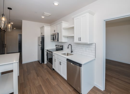 a kitchen with white cabinets and stainless steel appliances and a white counter top at The Crossings  at Windsong, Prescott Valley, AZ