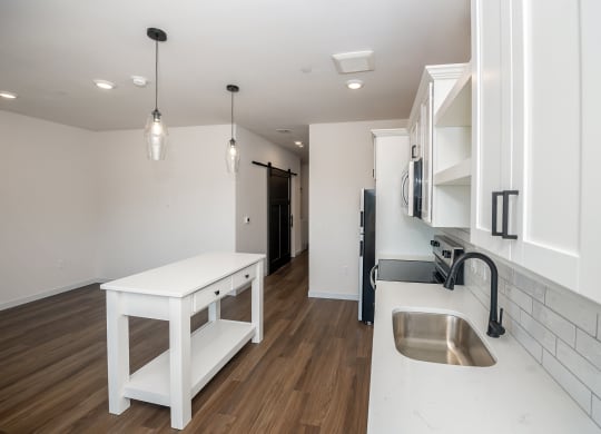 a kitchen with white cabinets and a sink and a counter top at The Crossings  at Windsong, Prescott Valley, 86314