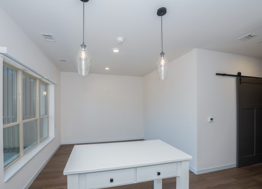 a dining room with a white table and a large window at The Crossings  at Windsong, Prescott Valley, AZ