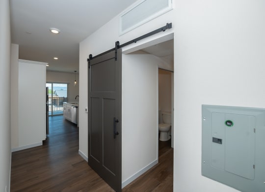 a sliding barn door in a living room at The Crossings  at Windsong, Prescott Valley, 86314