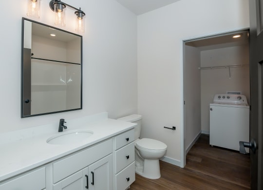 a bathroom with a sink and a toilet and a mirror at The Crossings  at Windsong, Prescott Valley, 86314