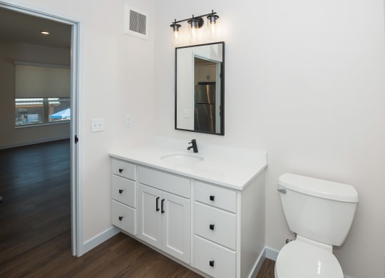 a bathroom with a toilet and a sink at The Crossings  at Windsong, Arizona