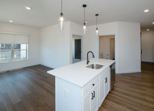 an empty kitchen with a white counter top in a new home at The Crossings  at Windsong, Prescott Valley, Arizona