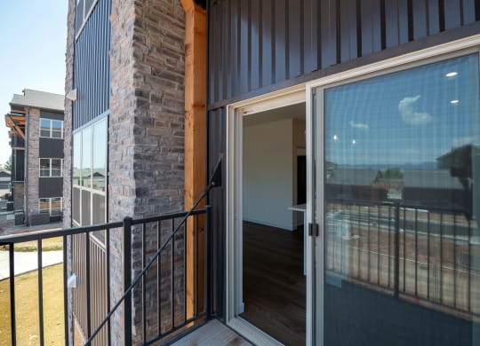 a sliding glass door on the balcony of a home at The Crossings  at Windsong, Prescott Valley, 86314