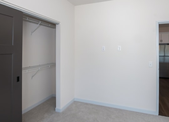 an empty bedroom with a closet and a door to the bathroom at The Crossings  at Windsong, Prescott Valley