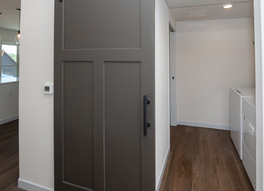 a bedroom with a door and a hallway with a laundry room at The Crossings  at Windsong, Prescott Valley, AZ