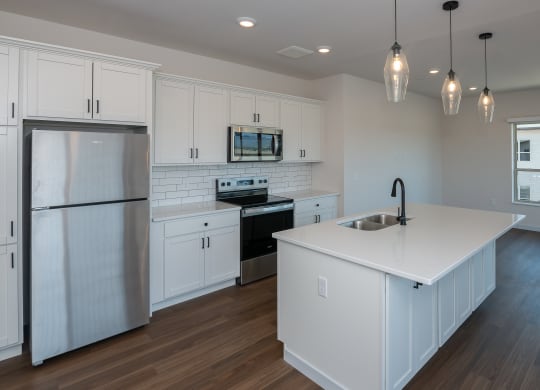 a kitchen with white cabinets and a white counter top at The Crossings  at Windsong, Prescott Valley, 86314