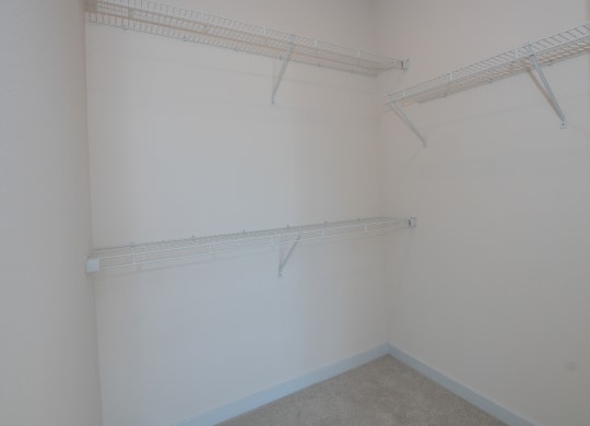 a room with a white wall and a hanging rack on the wall at The Crossings  at Windsong, Arizona, 86314