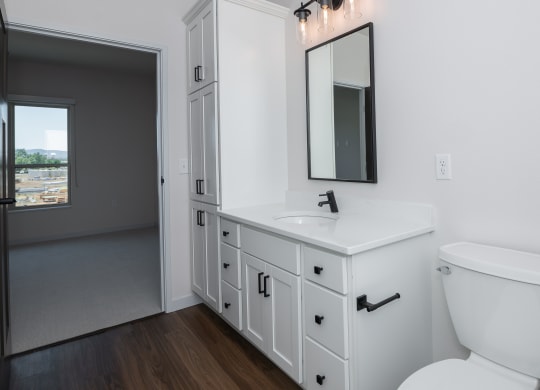 an empty bathroom with a toilet sink and mirror at The Crossings  at Windsong, Arizona, 86314