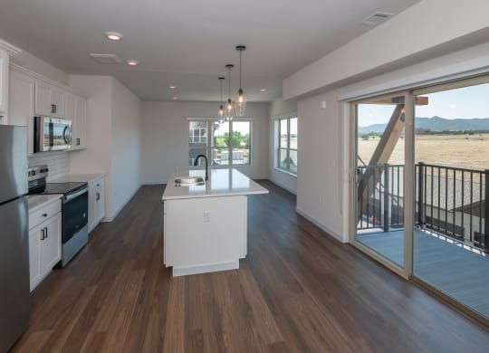 a kitchen with a white counter top and a large window at The Crossings  at Windsong, Prescott Valley, AZ