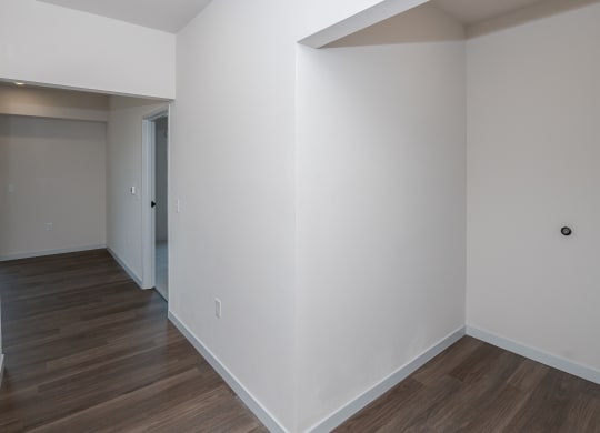 an empty room with white walls and a wooden floor at The Crossings  at Windsong, Arizona, 86314