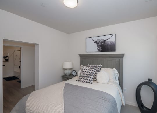 a bedroom with a bed and a picture of a bull at The Crossings  at Windsong, Arizona, 86314