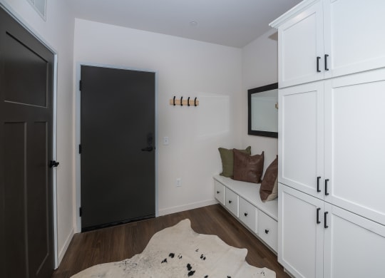 a room with white cabinets and a white couch and a black door at The Crossings  at Windsong, Prescott Valley, Arizona