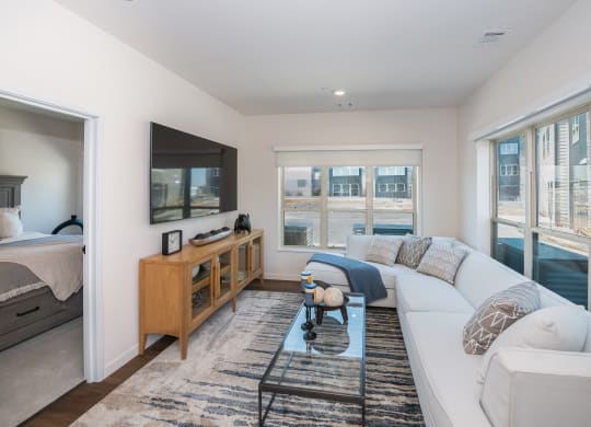 a living room with a white couch and a television at The Crossings  at Windsong, Prescott Valley, AZ