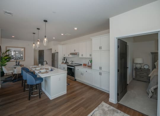 a kitchen and dining room with white cabinets and a white counter top at The Crossings  at Windsong, Prescott Valley, Arizona