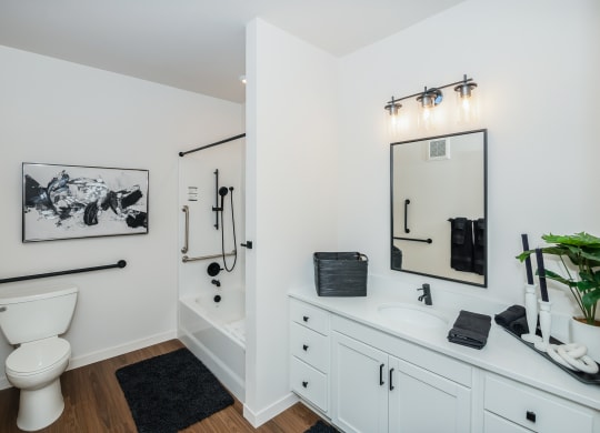 a bathroom with white cabinets and a toilet and a sink at The Crossings  at Windsong, Prescott Valley