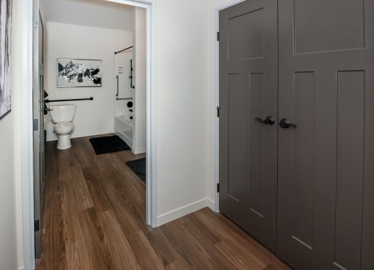 a door leading into a bathroom with a toilet and a sink at The Crossings  at Windsong, Prescott Valley, 86314