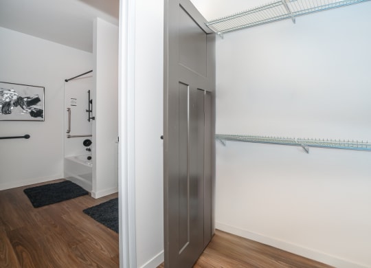 a closet in a room with white walls and wood floors at The Crossings  at Windsong, Arizona, 86314