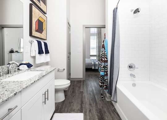 A bathroom with a white tub and a white toilet.