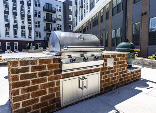 A brick wall with a silver oven on top.