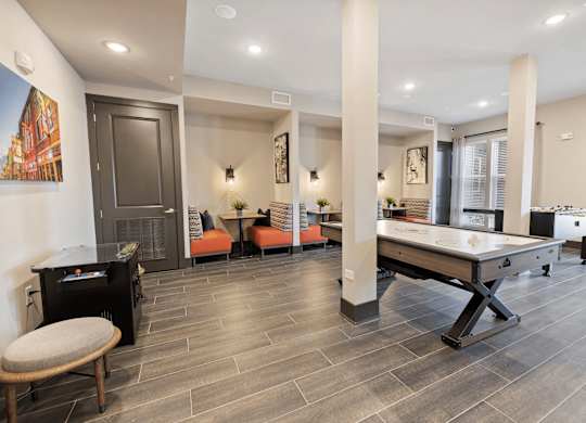 A room with a pool table and a fireplace.