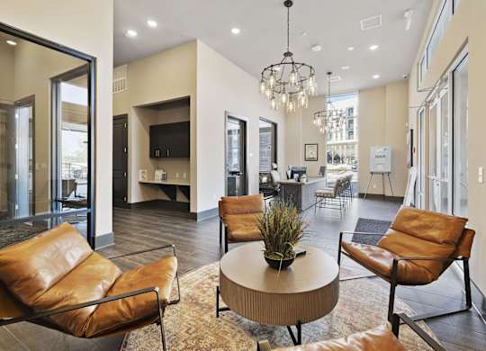 A living room with brown leather chairs and a round table.
