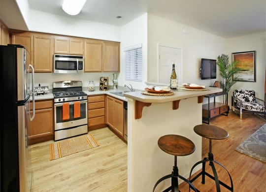Apartments in Goleta for Rent Willow Springs- Kitchen with Wooden Cabinets, High Bar Stool Countertops, and Stainless-Steel Appliances