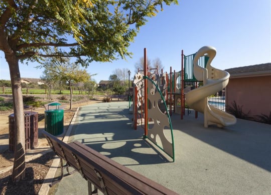Goleta Apartments- Willow Springs- Playground with Play Area, Padded Flooring, and Park Benches