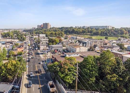 A city street with cars and buildings in the background.