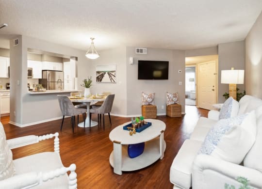 a living room and dining room with a couch and a table at The Villages of Banyan Grove, Boynton Beach, 33436