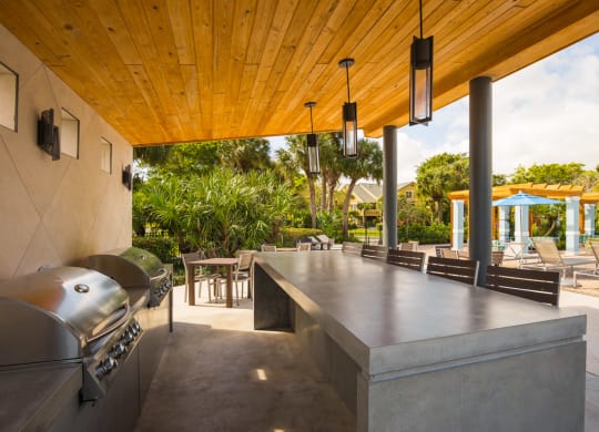 Grills and outdoor kitchen at The Villages Apartment of Banyan Grove Apartments in Boynton Beach FL