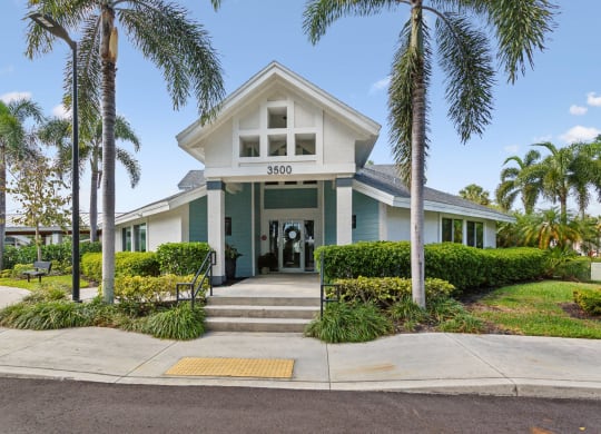 the front of a house with palm trees at The Villages of Banyan Grove, Florida, 33436