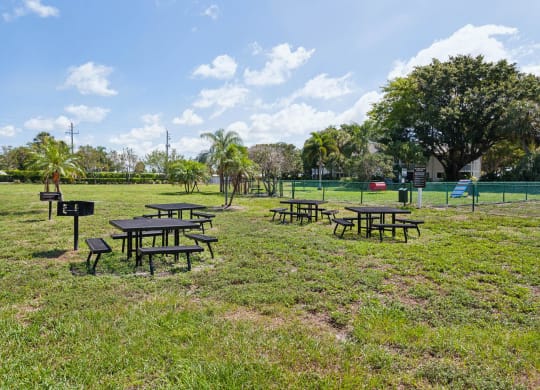 a group of picnic tables in a park at The Villages of Banyan Grove, Florida, 33436
