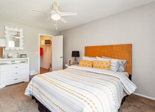 a bedroom with a large bed and a ceiling fan at The Villages of Banyan Grove, Boynton Beach, 33436