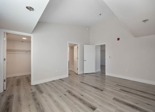 a renovated living room with white walls and wood floors  at Track 281 Apartments, Sacramento, 95811