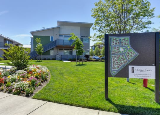 Addison Ranch Apartments Company Sign with  Wood Chip Floor, Flower Beds, Fire Hydrant, and Road at Addison Ranch Apartments, California, 94954