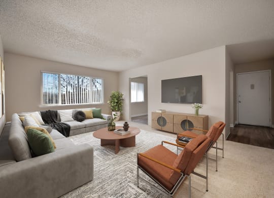 the living room of an apartment with a couch and chairs