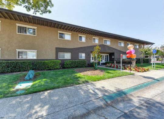 Building Entrance with Grass, Walkways and Tree  at Olympus Park Apartments, Roseville, CA
