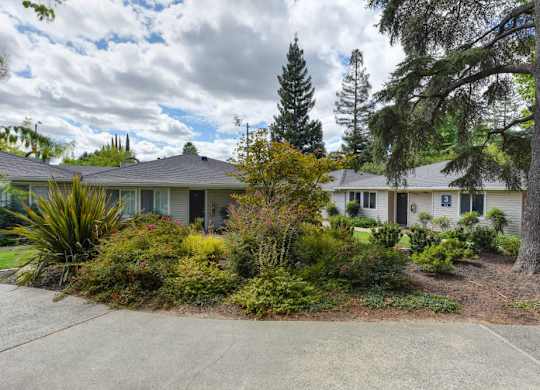 Building Exterior and Landscaping, with Walkway and Trees at The Renaissance Apartments, Citrus Heights California