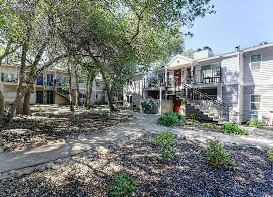 Apartment Exterior with Trees, Bushes and Walkway at Hidden Oaks Apartments, California