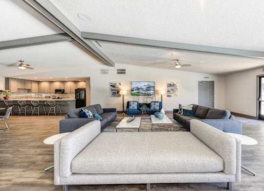 Community Clubhouse with Large Cushioned Bench Seating and More Couches in Distance at The Renaissance Apartments, Citrus Heights, 95610
