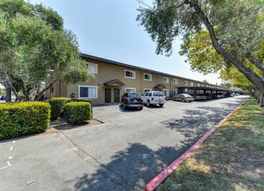 Community Exterior with Parking Lot  at Olympus Park Apartments, California, 95661