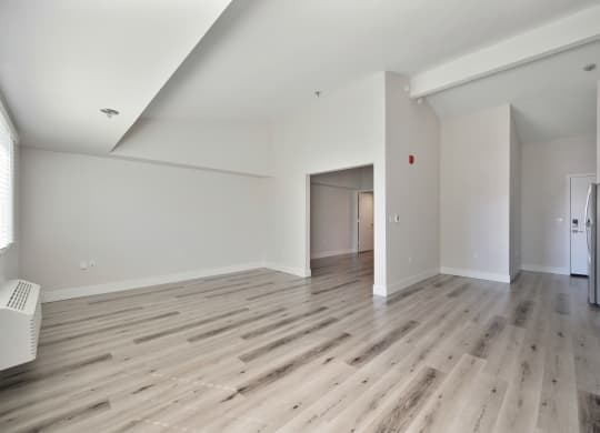 a renovated living room with hardwood floors and white walls  at Track 281 Apartments, Sacramento, CA, 95811