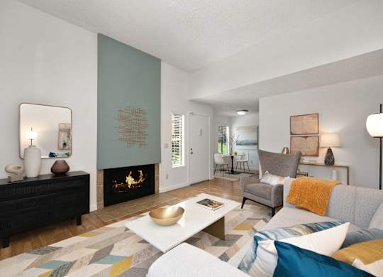 a living room with a fireplace and a couch at Fountains of Fair Oaks, California