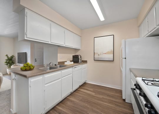 a kitchen with white cabinets and a sink and a refrigerator