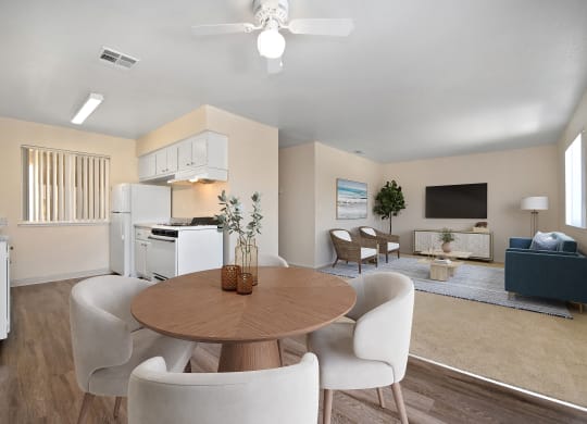 a living room with a dining room table and chairs