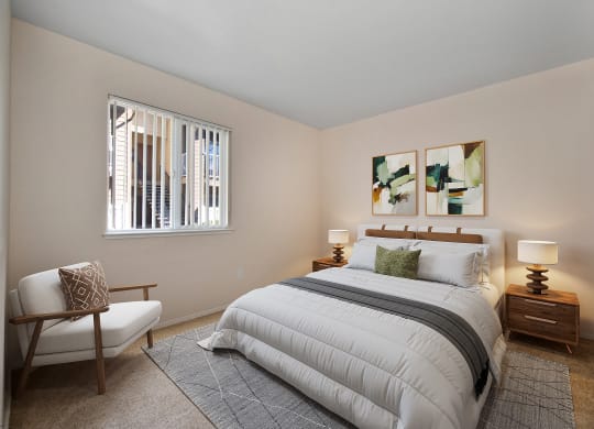 a bedroom with a bed and a chair and a window