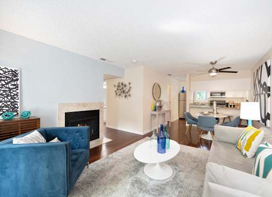 Living area with fireplace and dining area at Hidden Oaks Apartments, Citrus Heights