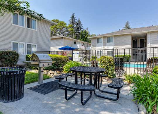 Outdoor BBQ and picnic area outside of the gated pool area.at The Renaissance Apartments, Citrus Heights, 95610